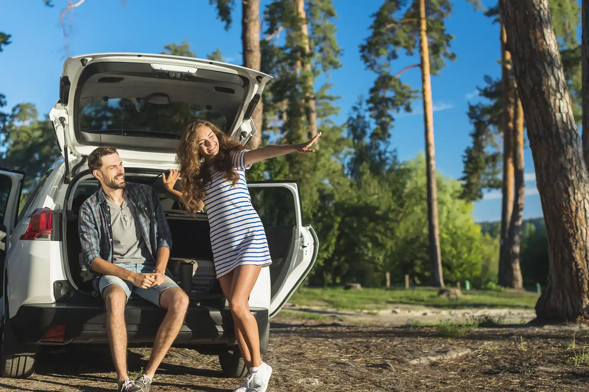 Young couple enjoying a road trip in Montenegro with a rental car